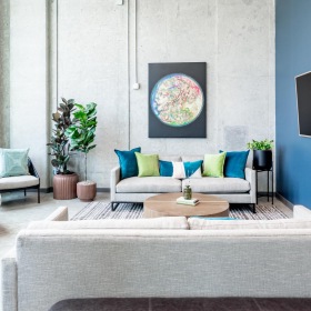 a lounge area with a tv, couches and chairs