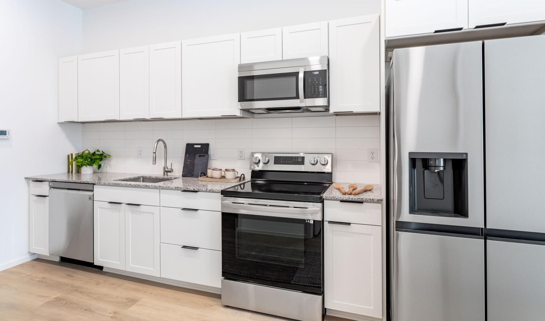 a kitchen with white cabinets