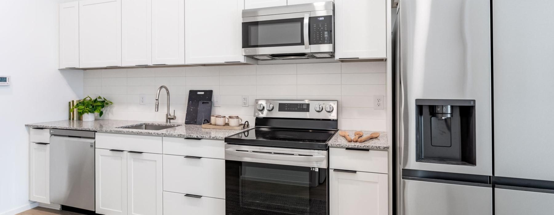 a kitchen with white cabinets
